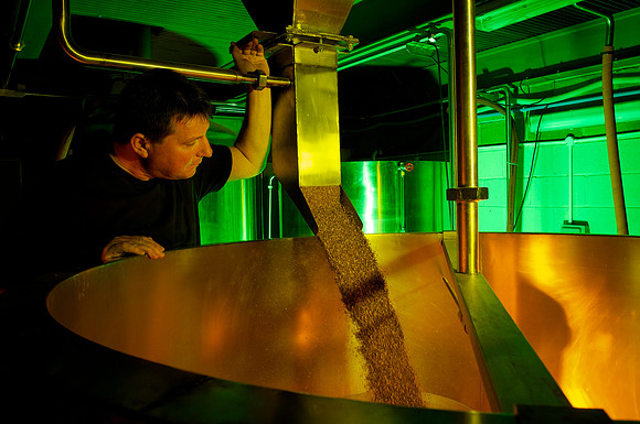 Brewing specialist inspects his recipe- Swansea