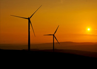 Wind turbines at sunset in South Wales valleys.